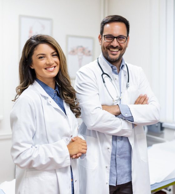 Two smiling doctors in white coats at the clinic